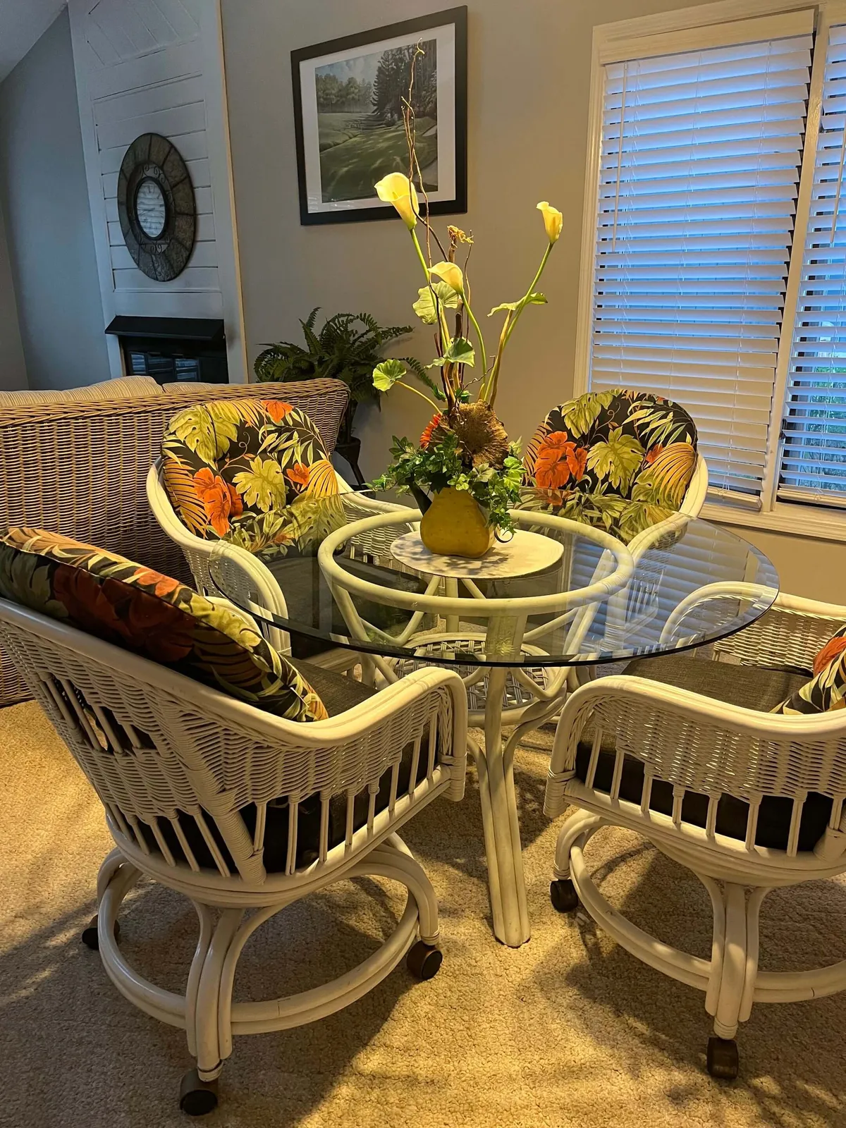 The image showcases a bright, inviting dining area featuring a glass table surrounded by colorful chairs, a vibrant floral centerpiece, and cheerful artwork adorning the wall. The space is styled for shared meals, lively conversations, and relaxed gatherings, capturing the heart of the condo's communal living.